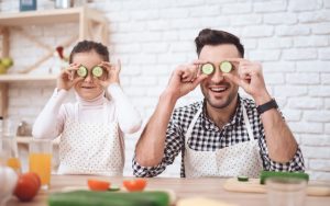 Father Daughter with cucumbers on eyes