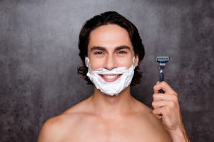 Man shaving face