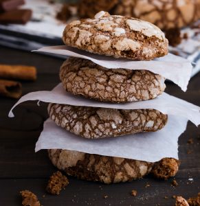 Chocolate Cookies Stacked Between Parchment Paper