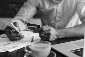 Man with credit card and phone - black and white