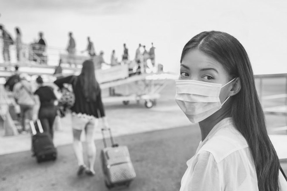 Woman Traveling wearing a mask
