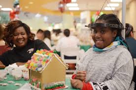 child decorating gingerbread house Cookies & Castles event