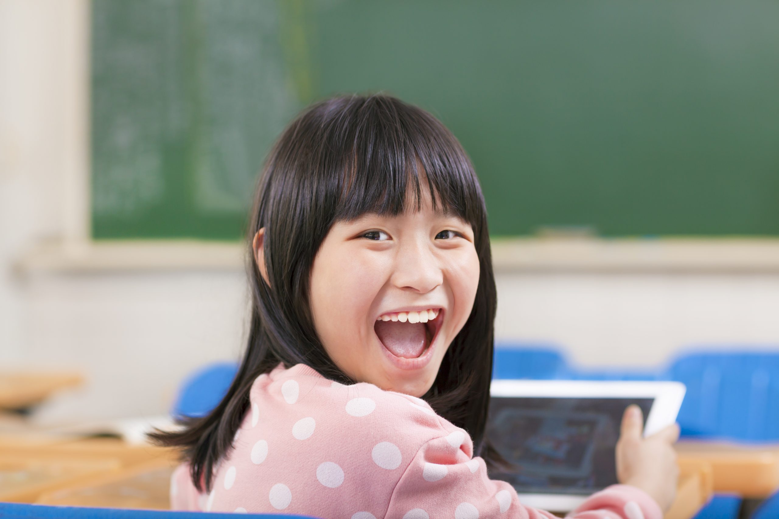 Happy,Little,Girl,Holding,Digital,Tablet,Ipad back to school shopping advertising digital trends