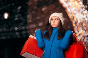 Tired,Girl,Holding,Shopping,Bags,On,Christmas,Lights,Decor.,Exhausted