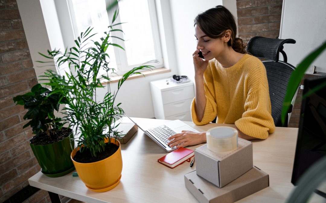 b2b sales advertising woman on phone at desk with plant