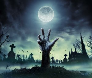 hand reaching out of a grave with moon shining in the background