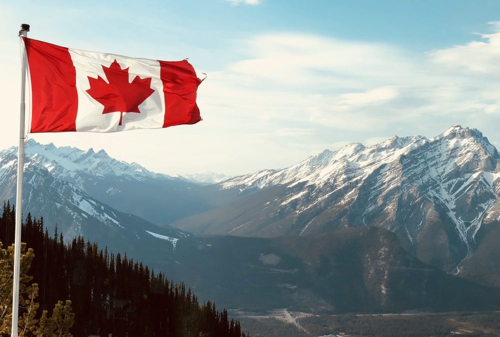 canadian flag with mountains behind