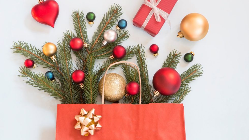 gift bag filled with holiday presents christmas decorations ornaments and gifts holiday ad tech trends and tips