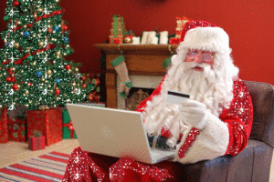 santa holding a credit card for holiday shopping online christmas shopping advertising