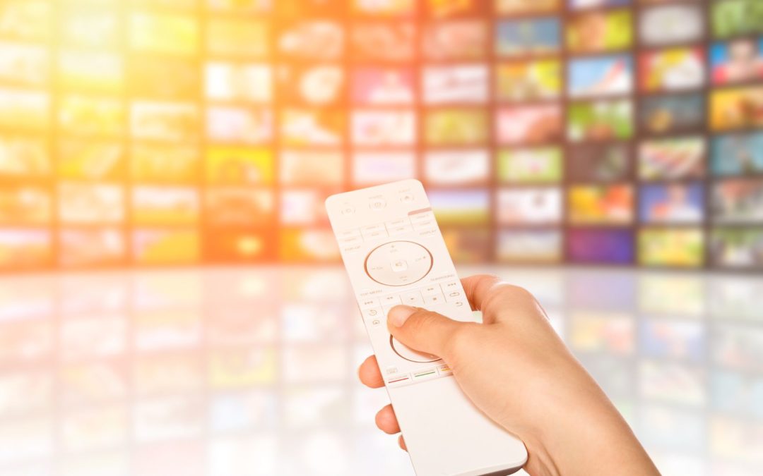 viewer holding remote choosing a streaming tv show out of an array of choices - ctv and ott advertising bidtellect